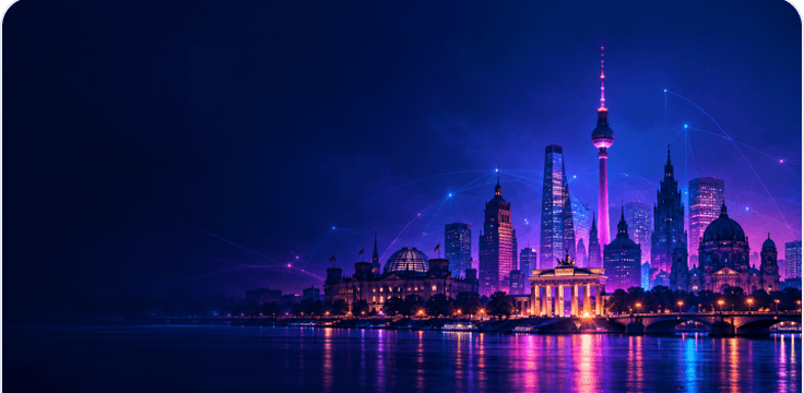 A night skyline of glass towers lit violet and pink, mirrored in the water below.
