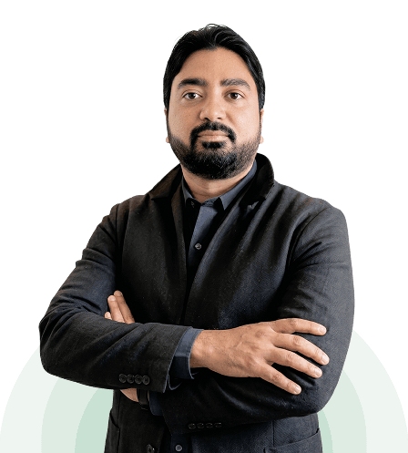Brijesh Prasad Gupta, Founder & CEO, standing with his arms folded in a dark jacket.